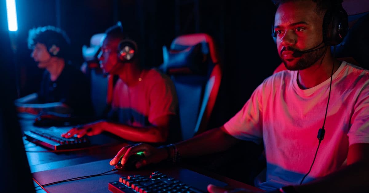 Young men engrossed in a competitive eSports gaming session, displaying teamwork and focus.