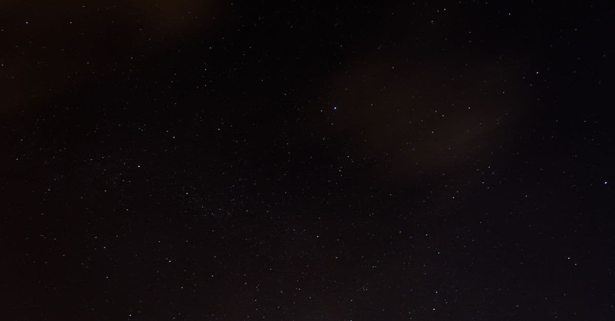 A serene night sky dotted with stars, featuring a hint of cloud coverage, perfect for tranquil themes.