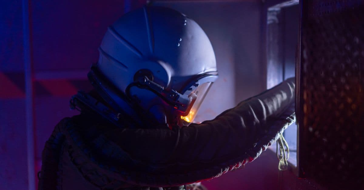 Astronaut in a futuristic space suit exploring a spacecraft with vivid lighting.