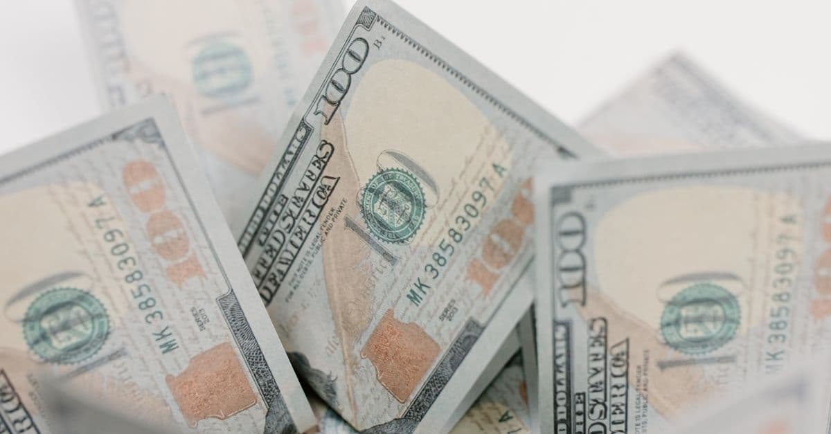 Close-up of US hundred dollar bills, ideal for finance or economic concepts.