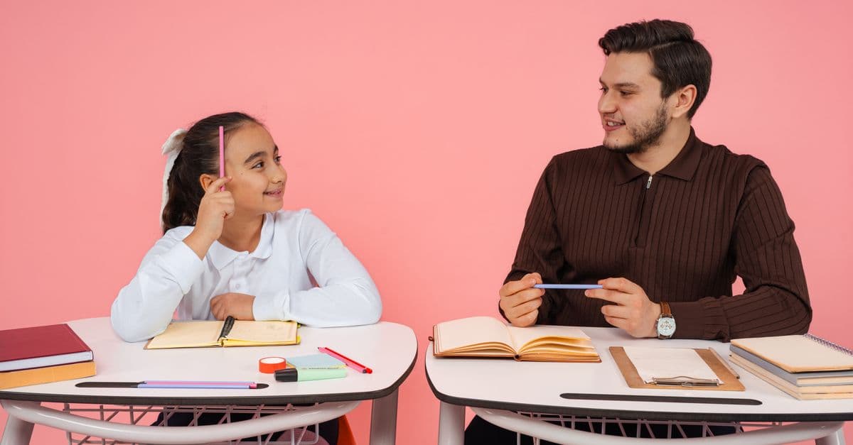 A teacher and student engaging in a lively discussion at school.