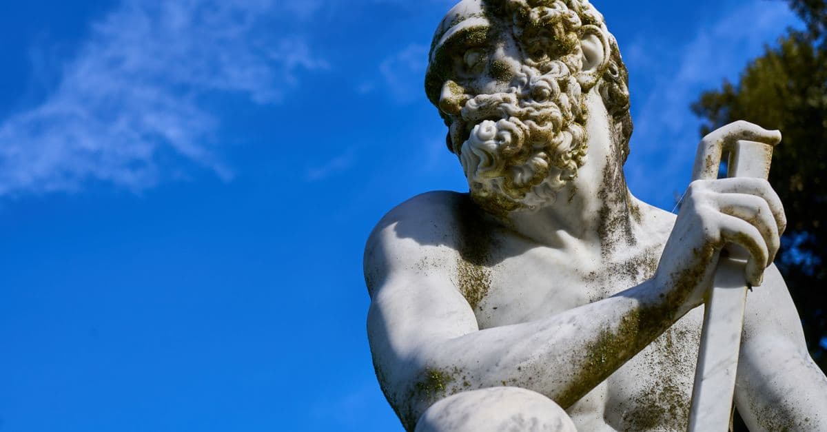 A classical marble statue against a vibrant blue sky, exuding timeless elegance and artistry.