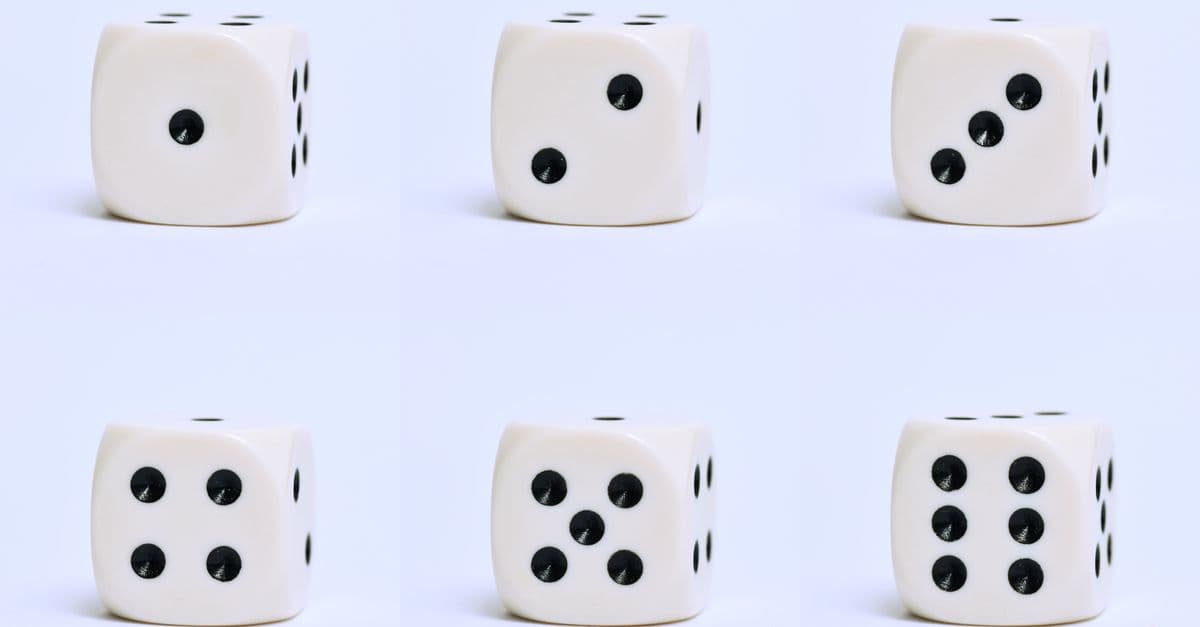 Detailed close-up of six white dice on a plain surface, focusing on different numbers.
