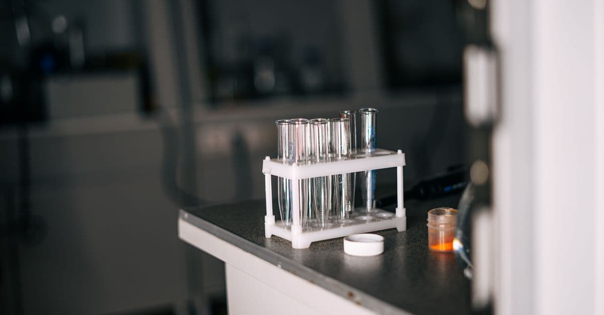 Close-up view of laboratory test tubes and equipment on a lab bench, enhancing scientific exploration.