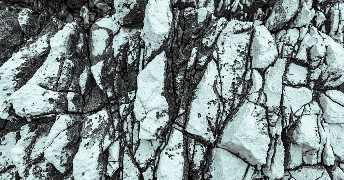 Detailed texture of white limestone rock formations in Poreč, Croatia, emphasizing nature's patterns.