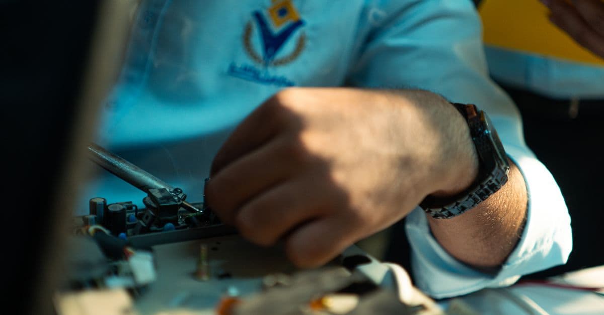 A detailed close-up of a technician working on machinery, highlighting skill and precision.