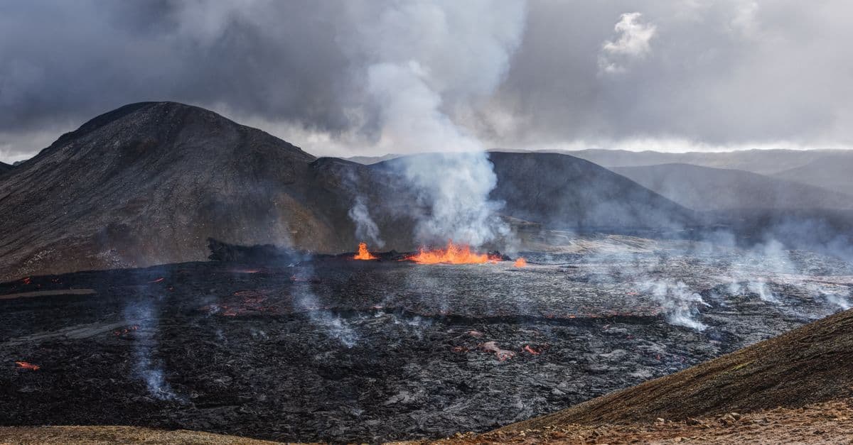 Captivating image of an active volcanic eruption with smoke and lava flow.