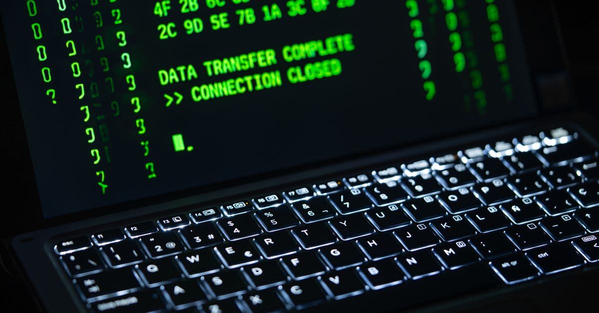Close-up of a laptop screen displaying green code text. Perfect for cybersecurity themes.