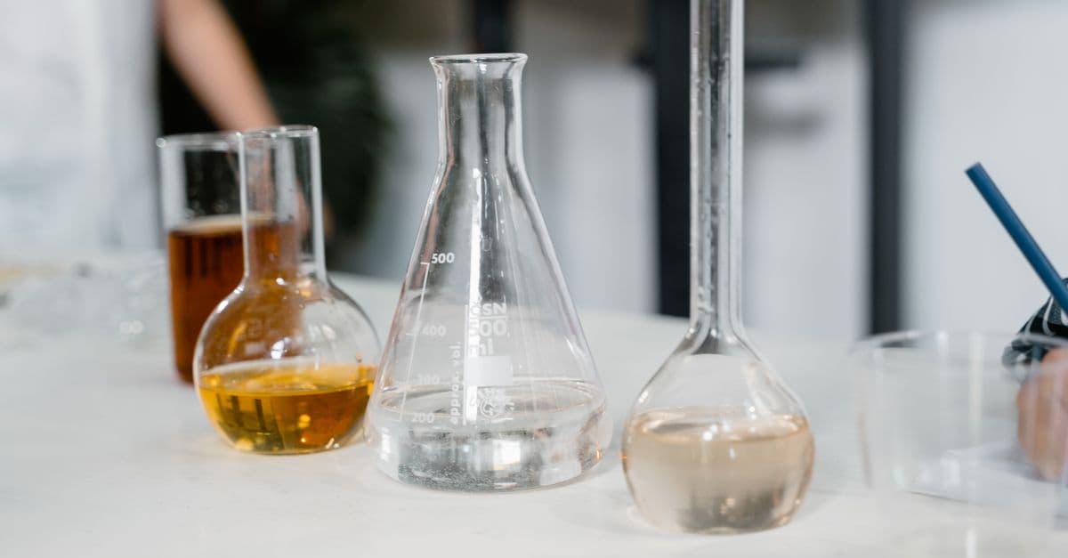 Laboratory glassware including beakers and flasks on a table during an experiment.