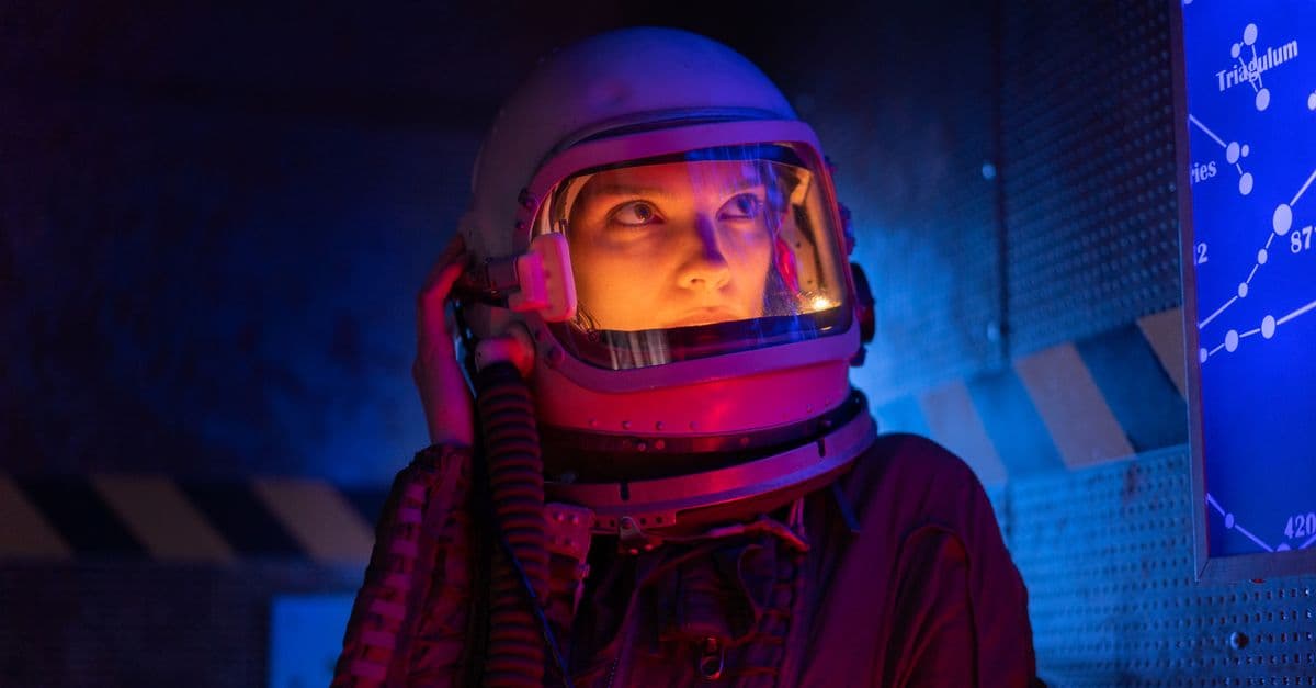 A futuristic astronaut in a space suit gazes at the star map, surrounded by vibrant lighting.