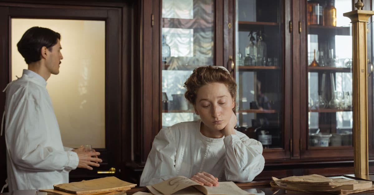 A contemplative scene with two scientists in a vintage laboratory setting.