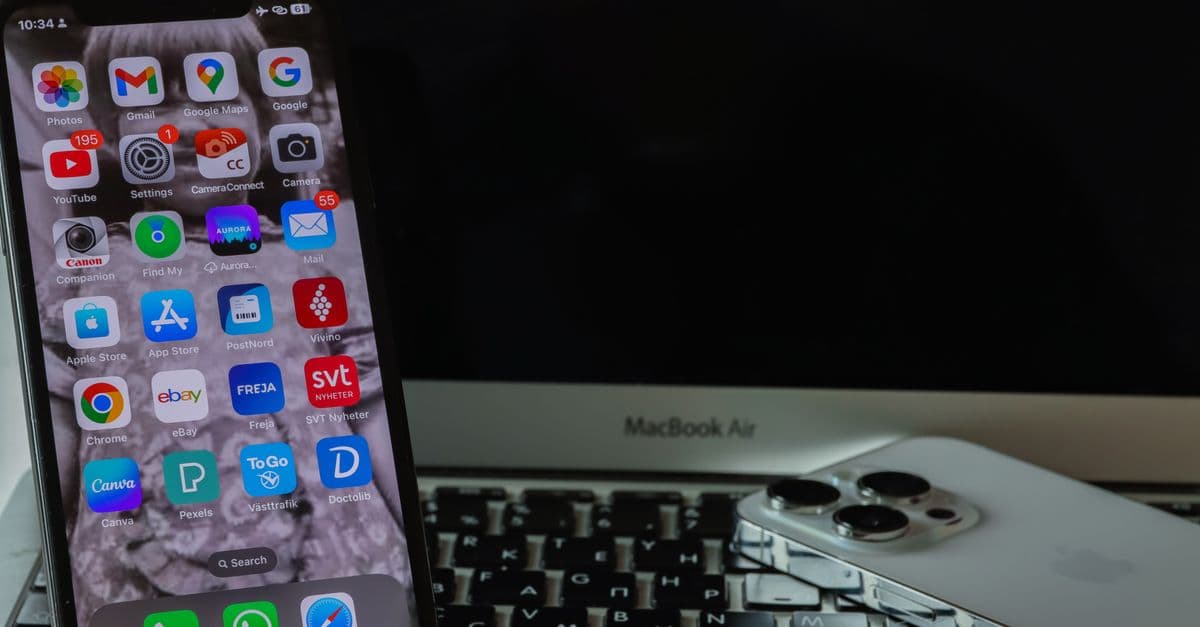 A smartphone and laptop setup showcasing a sleek, modern technology arrangement on a desk.