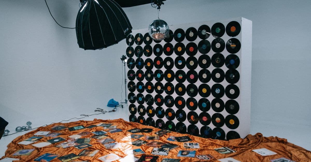A creative studio setup showcasing a wall of vinyl records and soft lighting.