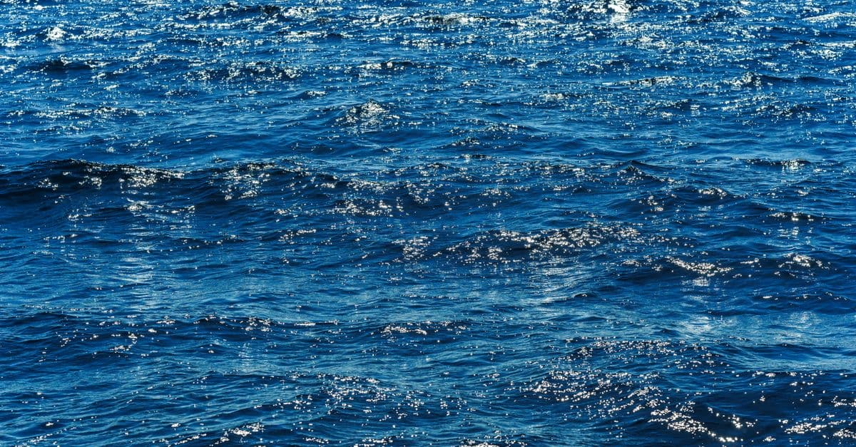 Vibrant blue ocean waves sparkling under the bright sun, showcasing the vastness of the sea.