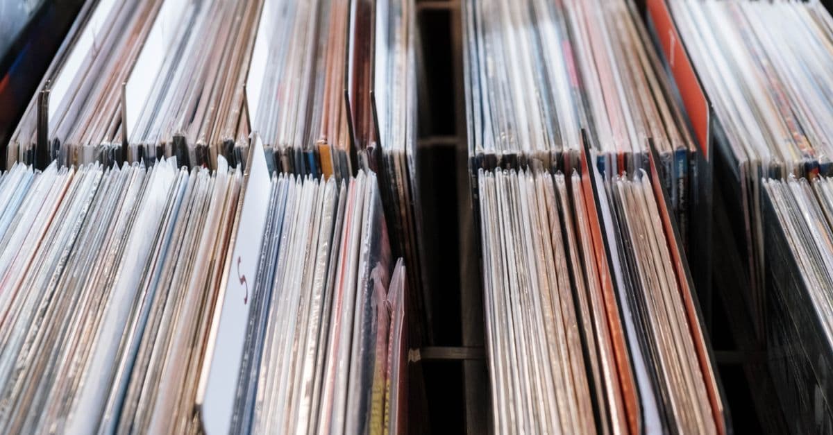 Close-up view of vintage vinyl records in a store setting, showcasing a retro music collection.