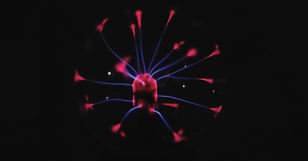 Bright glowing plasma ball with mystic colorful neon luminous placed in dark room