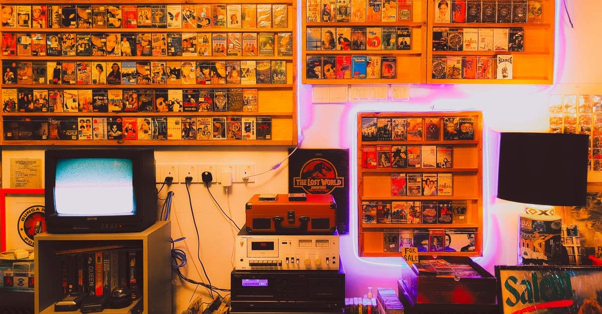 A nostalgic room with vintage audio equipment, tapes, and a retro TV.