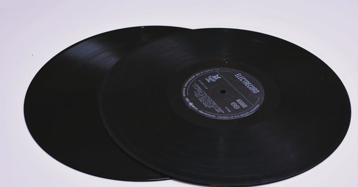 Close-up of two classic vinyl records on a flat surface, showcasing grooves.
