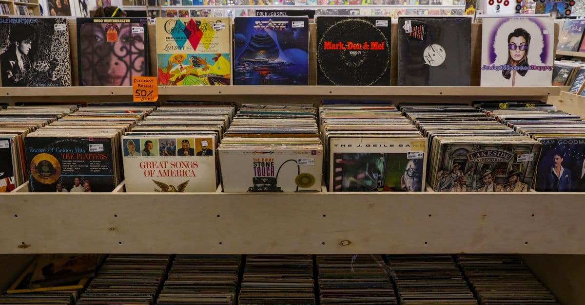 Browse a diverse collection of vintage vinyl records displayed in a Tulsa record shop.