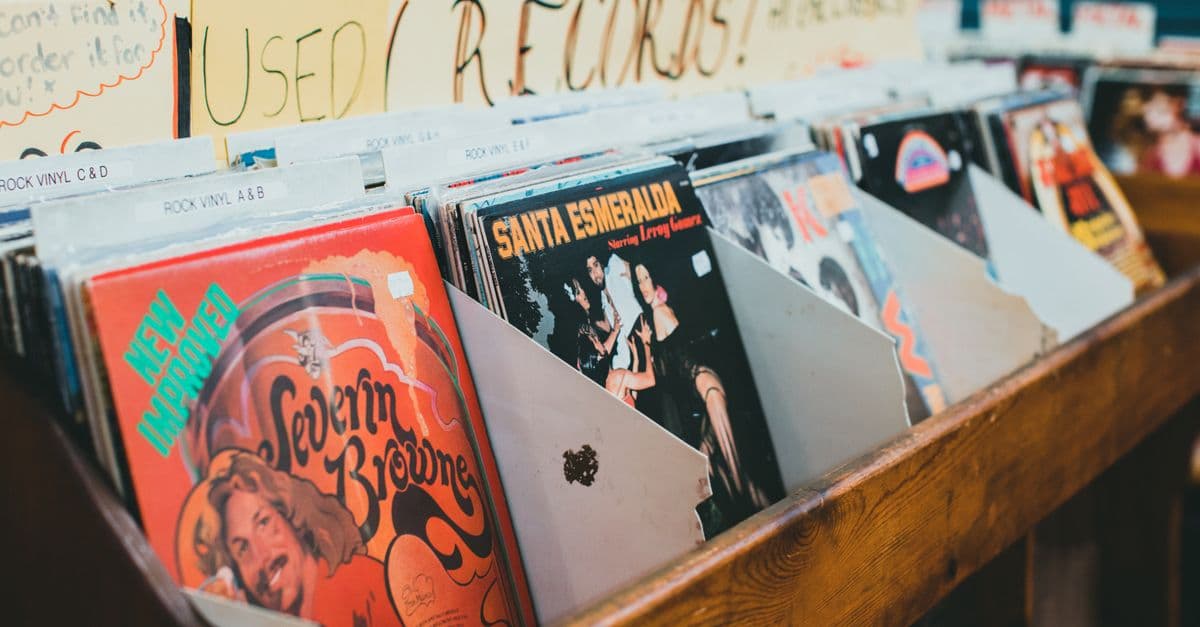 Close-up of vintage vinyl records in a music store display, emphasizing classic album covers.