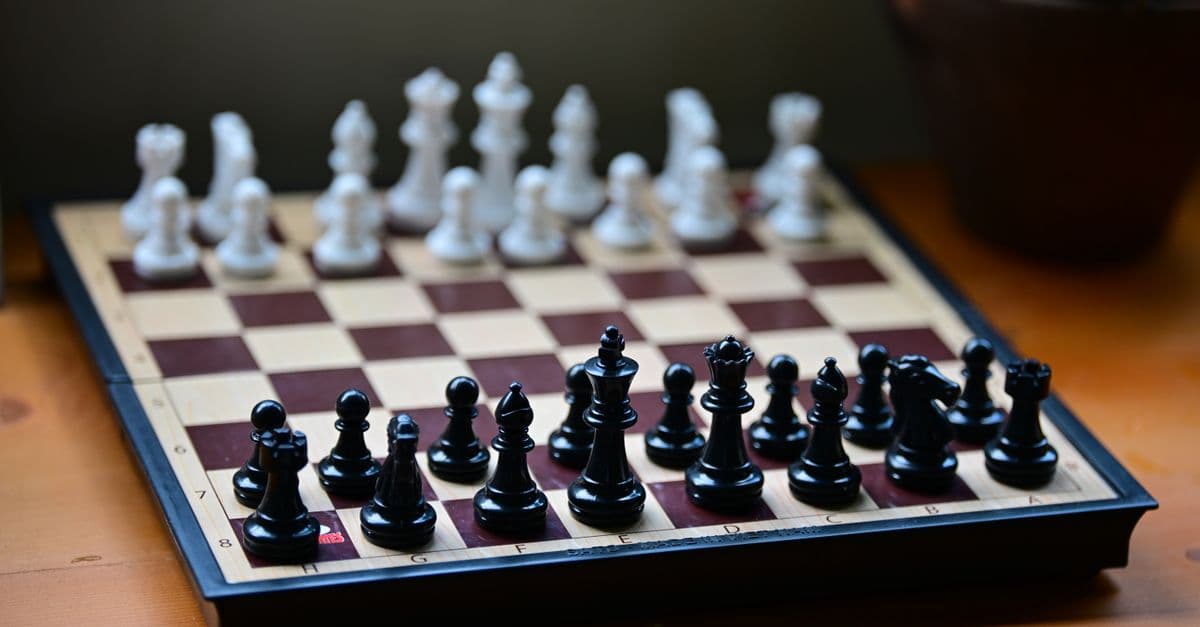 Chess board set with black and white pieces ready for a game. Perfect for strategy themes.