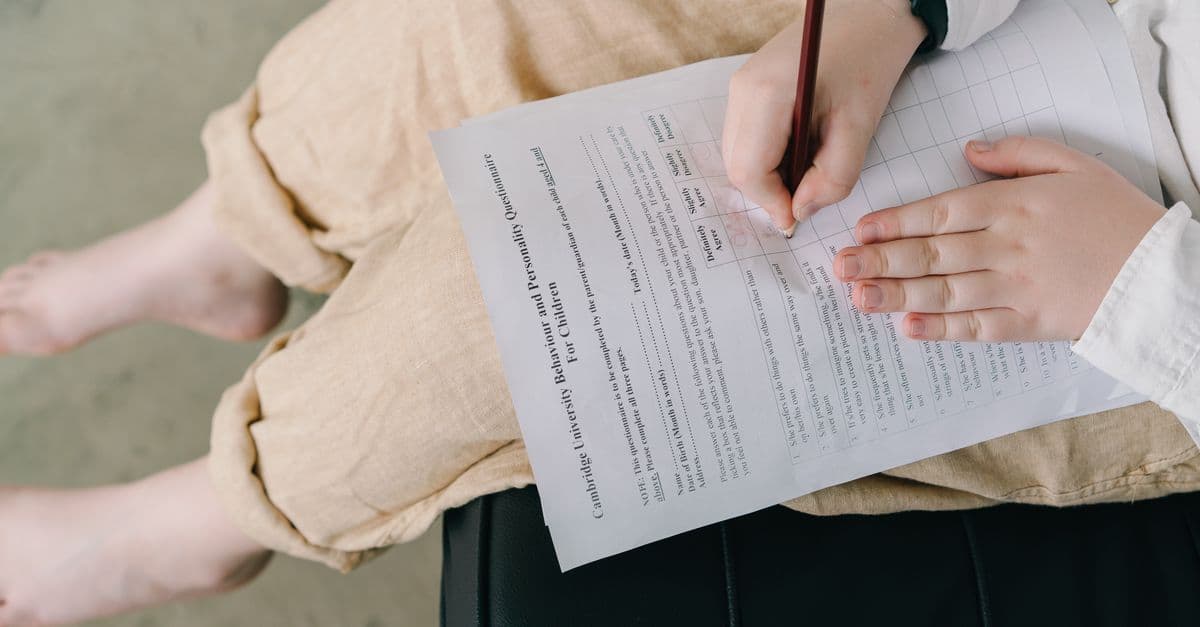 Young child completing a questionnaire indoors for educational purposes.
