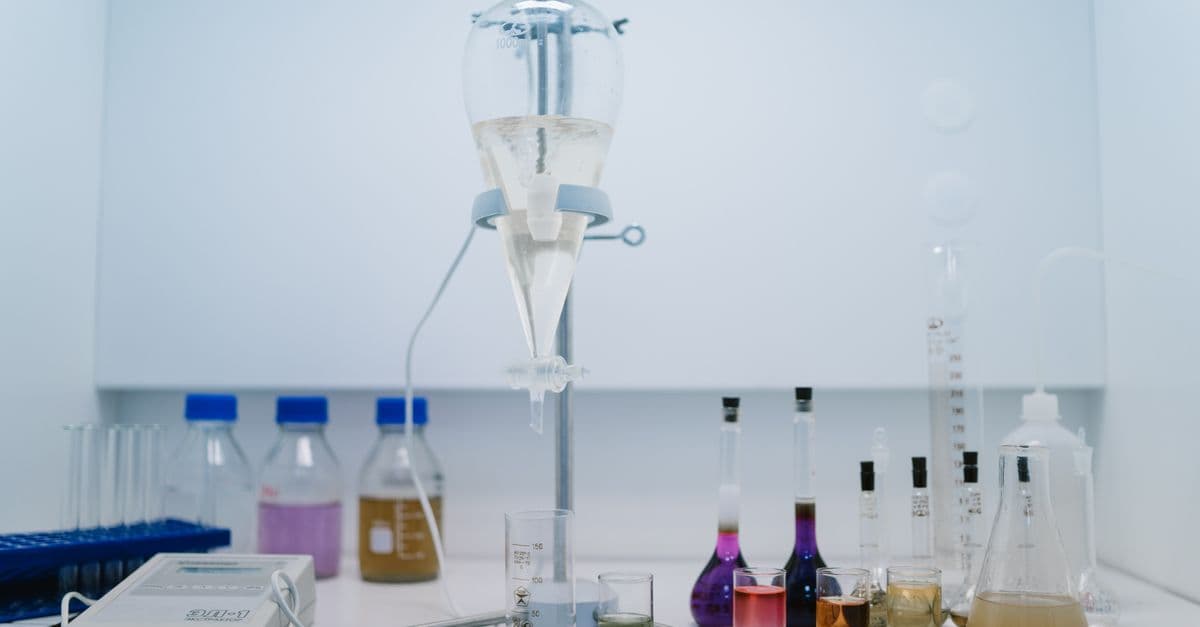 A detailed view of laboratory glassware with colorful chemicals, ideal for scientific research and experiments.