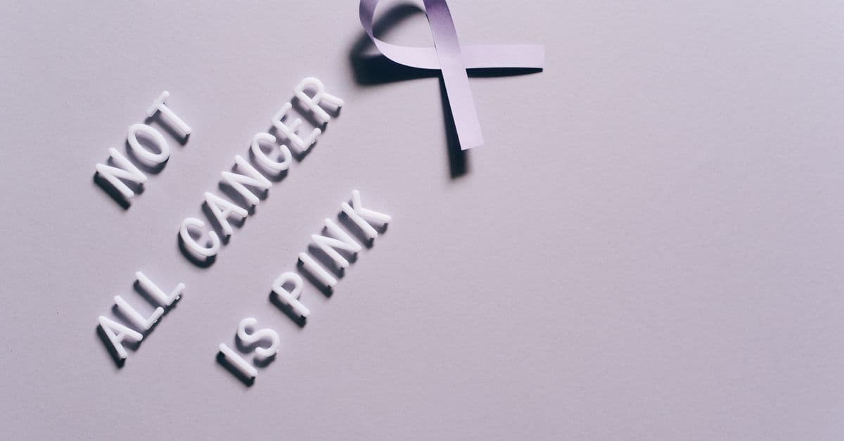 Cancer awareness poster with a purple ribbon on a gray background.
