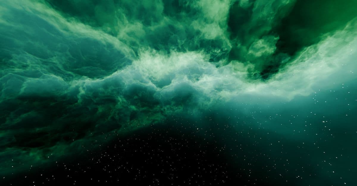 A vibrant green nebula in outer space with countless stars shining bright.