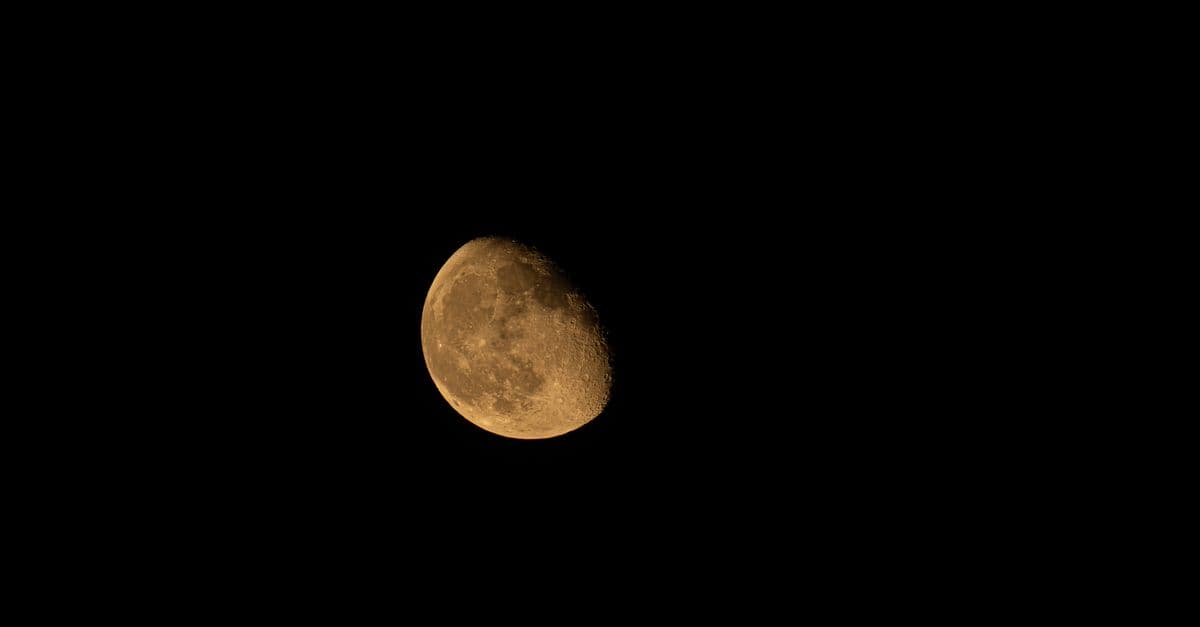 Detailed close-up of a waxing gibbous moon against the black night sky.