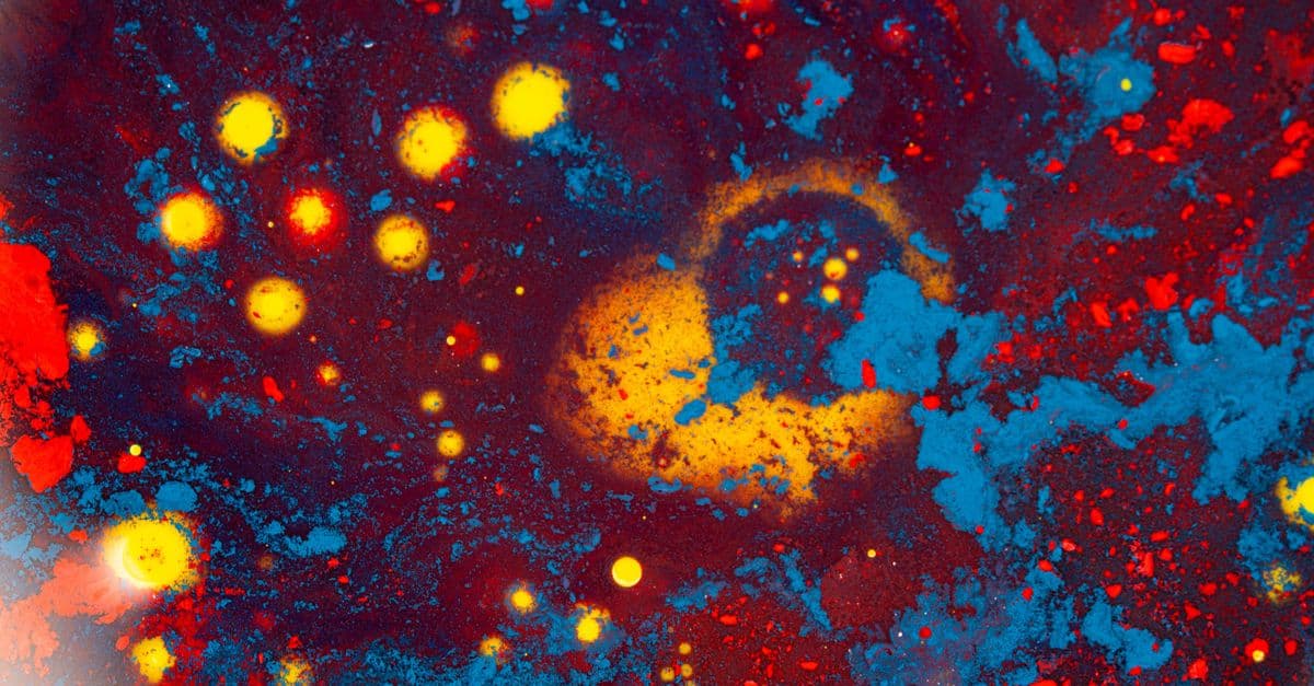 A vivid abstract pattern resembling a cosmic scene with colorful textures and patterns.