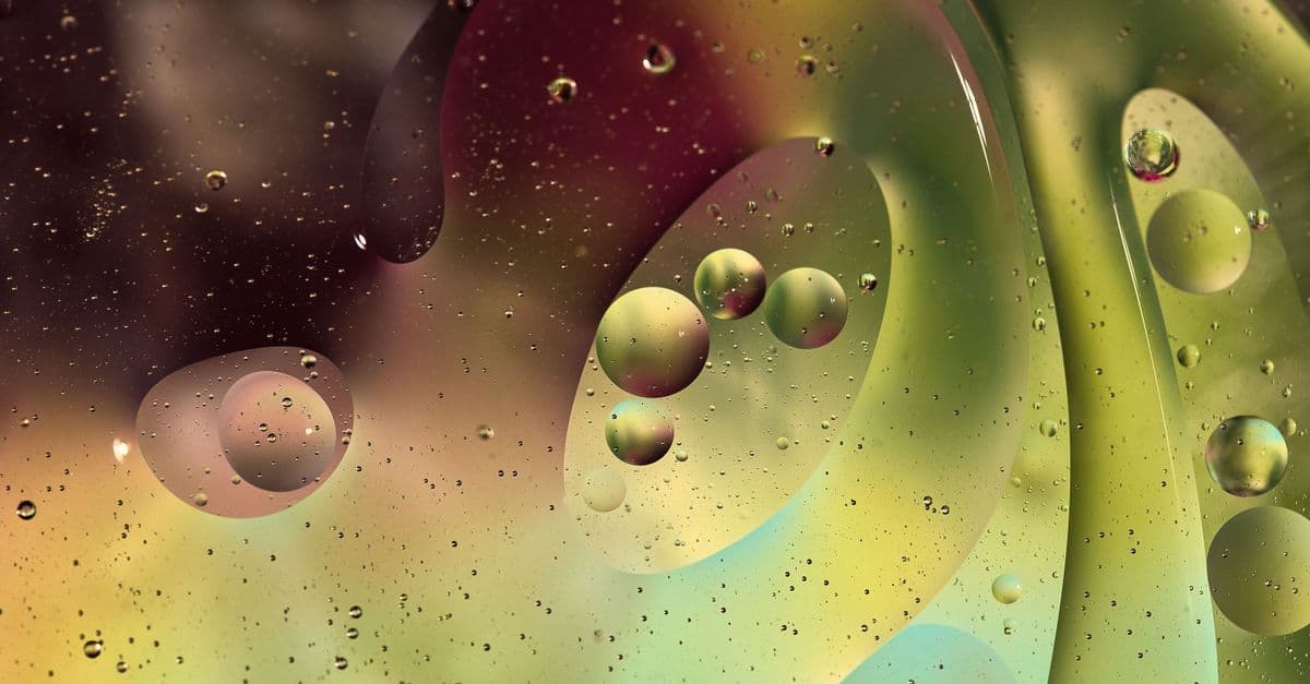 Vibrant abstract image of oil bubbles on water with a colorful background.