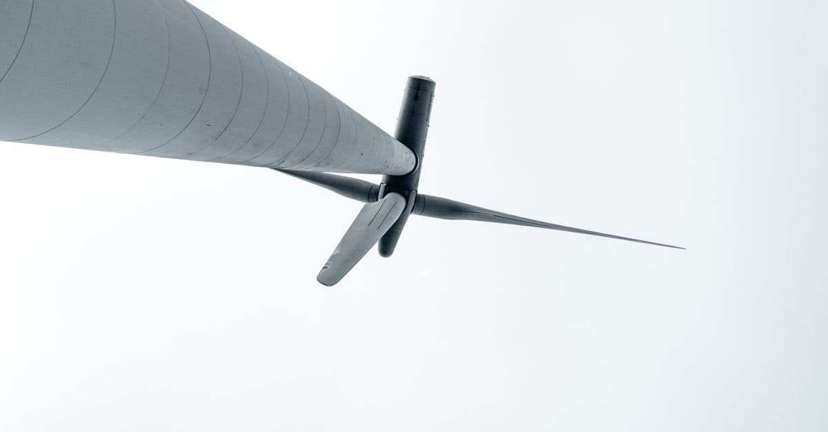 A low-angle view of a wind turbine symbolizing renewable energy and environmental sustainability.