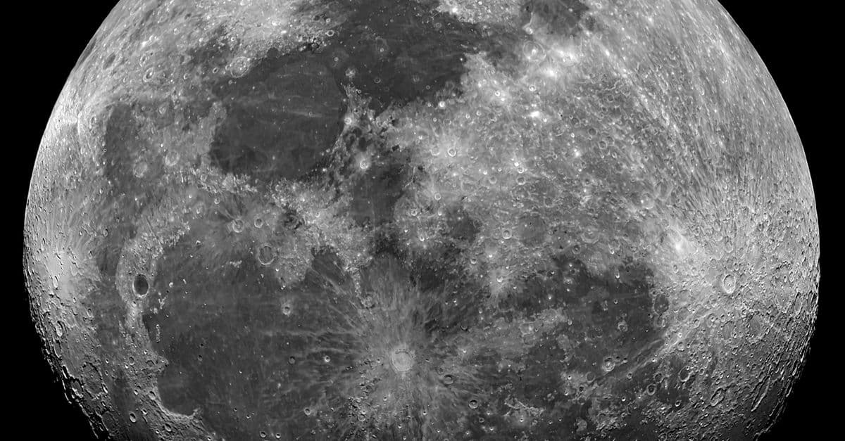 Black and white image of the detailed surface of the moon showing craters and textures.