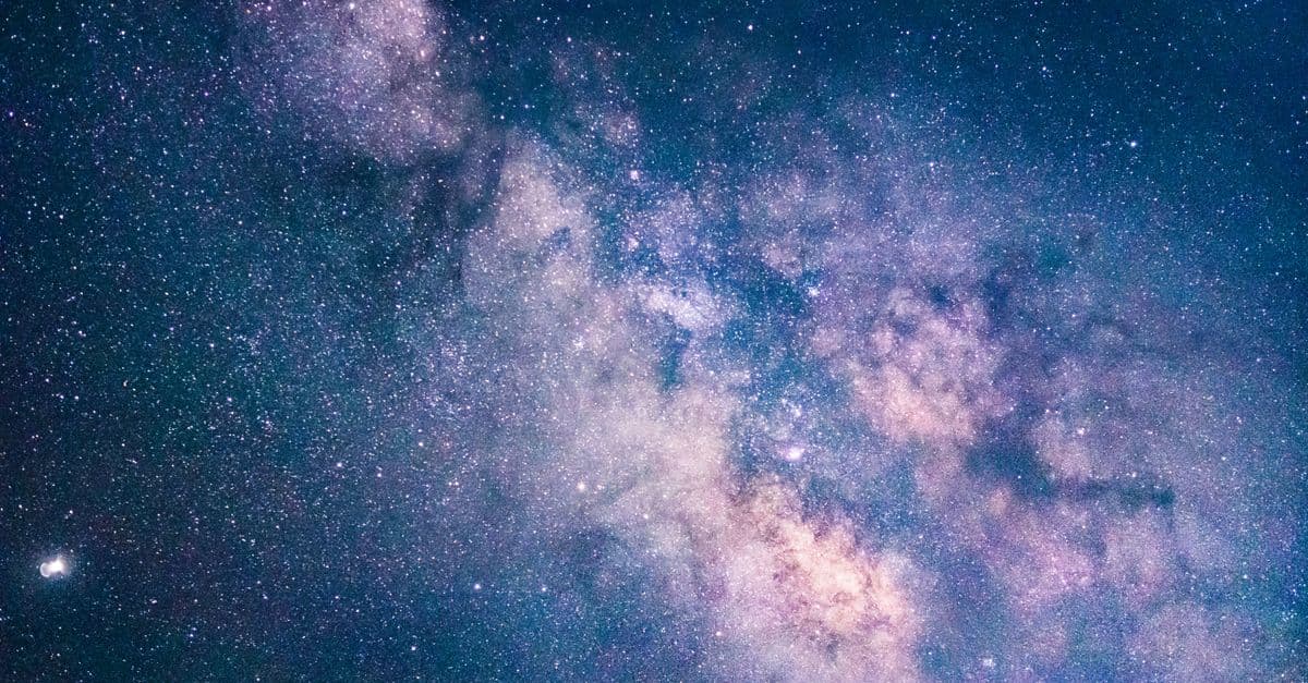Capture of the Milky Way galaxy illuminating the night sky over München's scenic landscape.