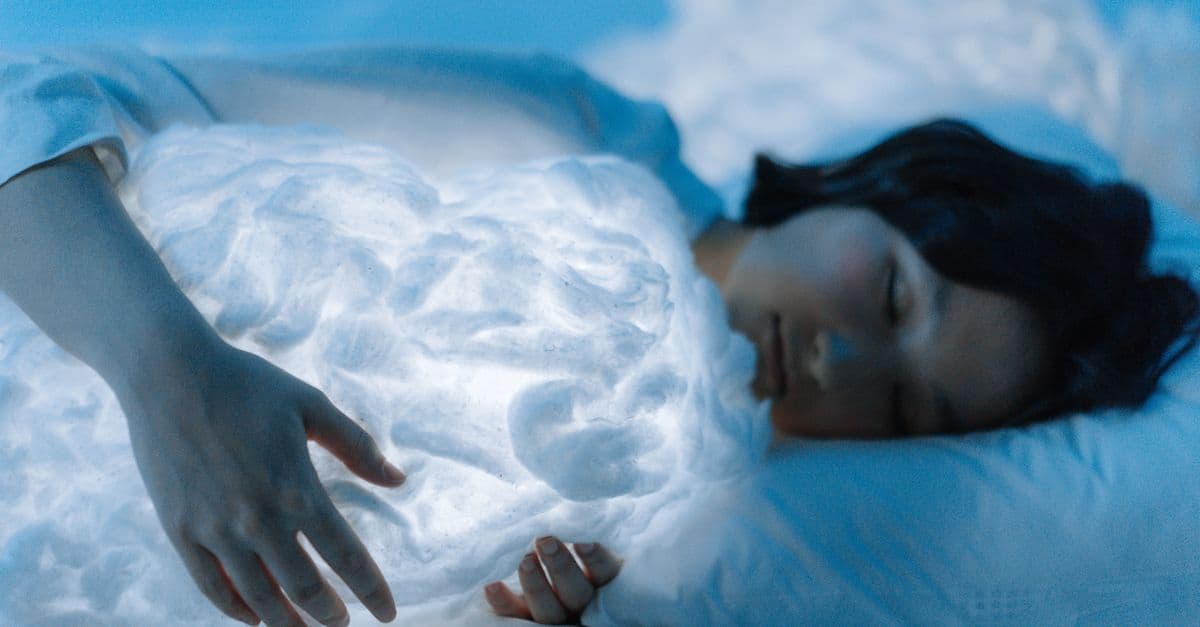 A serene image of a woman sleeping, clutching a glowing cloud pillow, evoking tranquility and dream-like states.