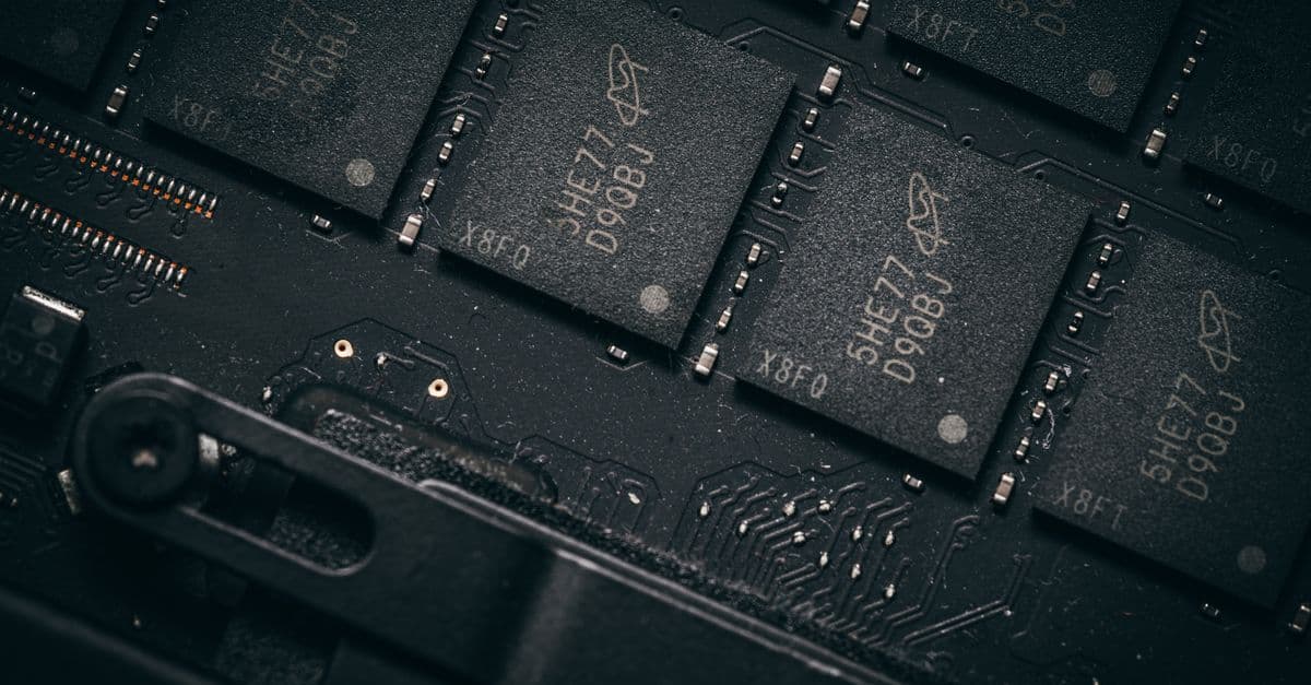 Detailed shot of microchips on a circuit board, showcasing electronic technology and precision engineering.
