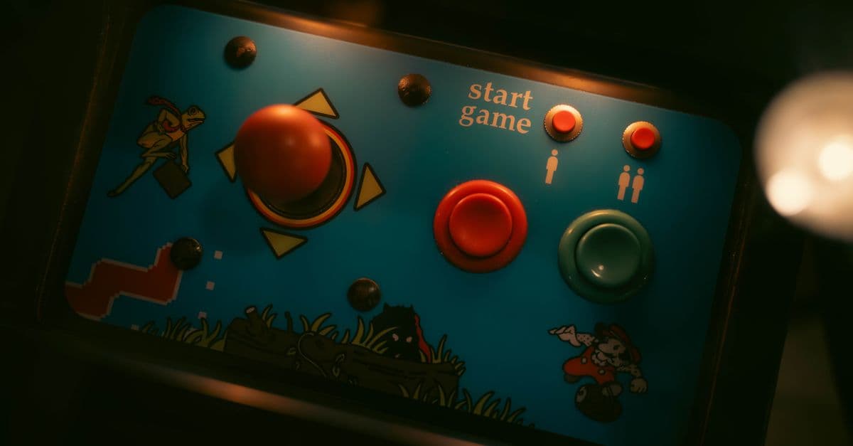 Close-up of retro arcade game controls with joystick and buttons