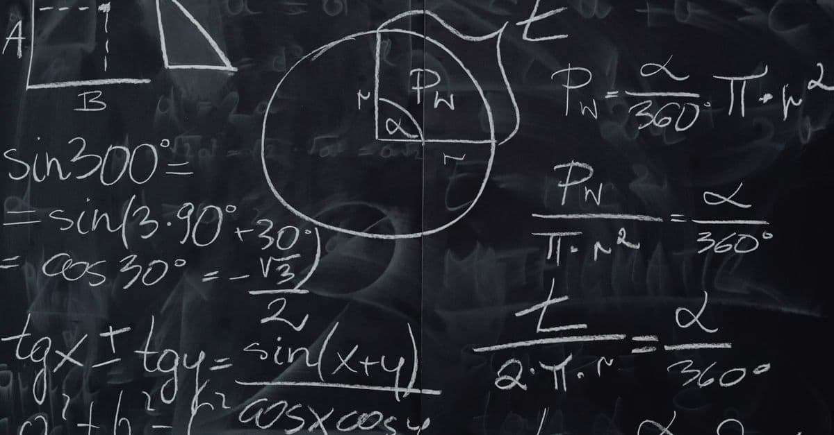 Complex trigonometric equations and geometric diagrams drawn on a classroom blackboard.