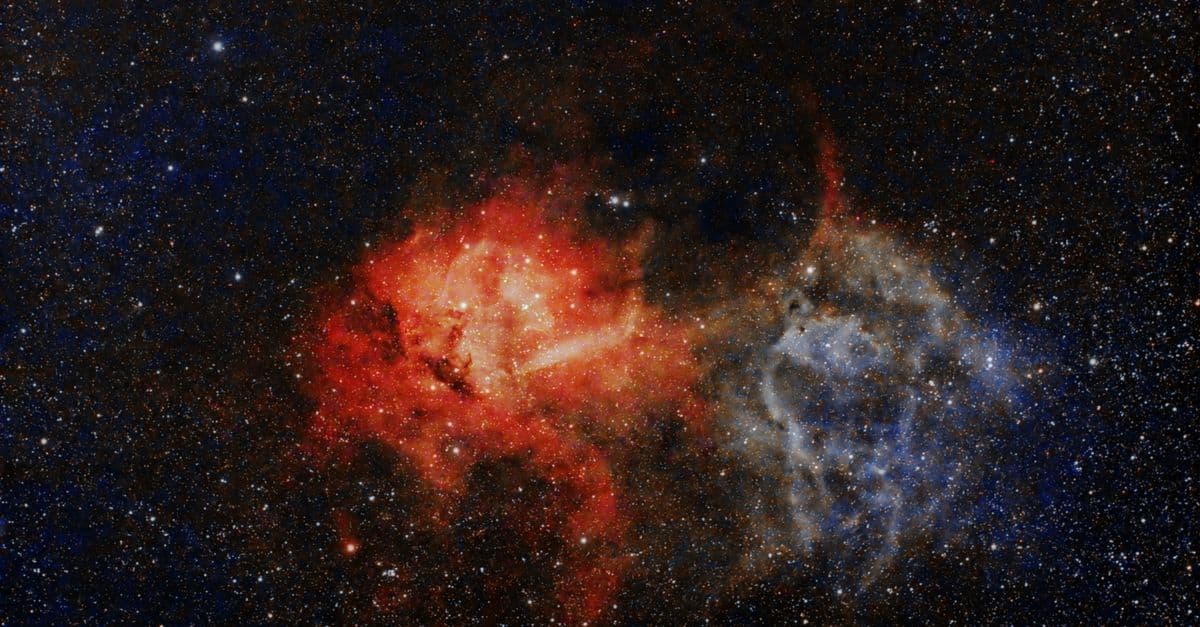 A captivating view of a colorful nebula surrounded by stars in a vast galaxy.
