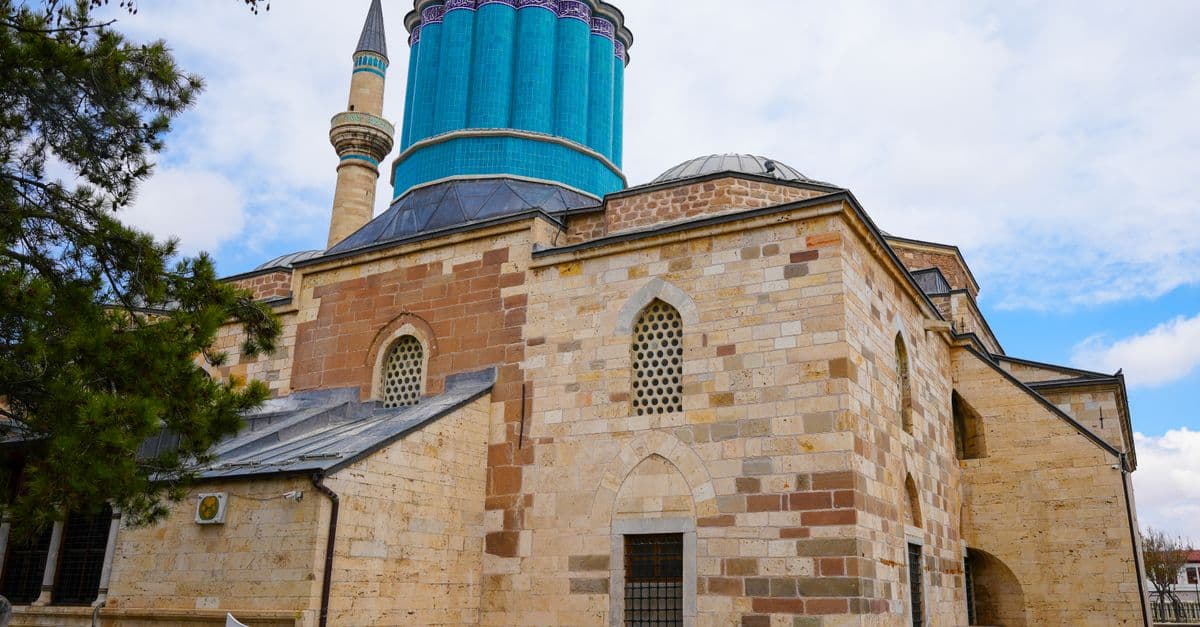 Explore the iconic Mevlana Museum in Konya, showcasing Islamic architecture with a vibrant turquoise dome.