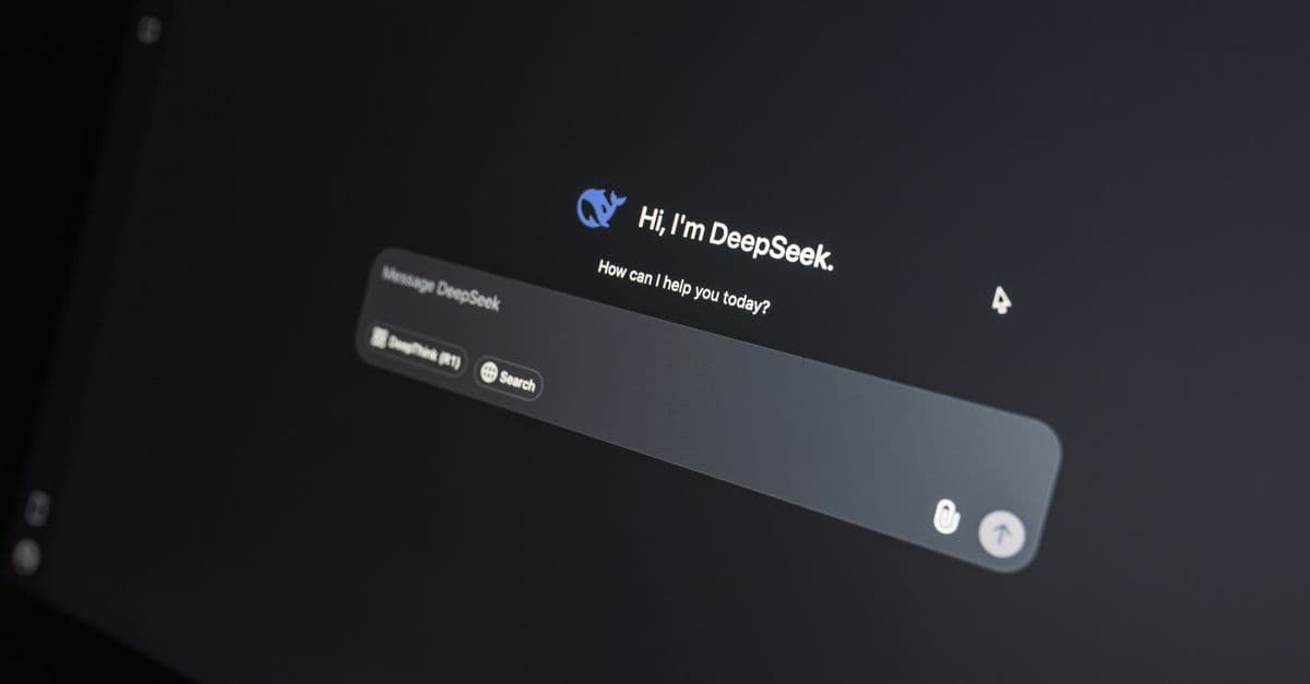 Close-up of DeepSeek AI chat interface on a laptop screen in low light.