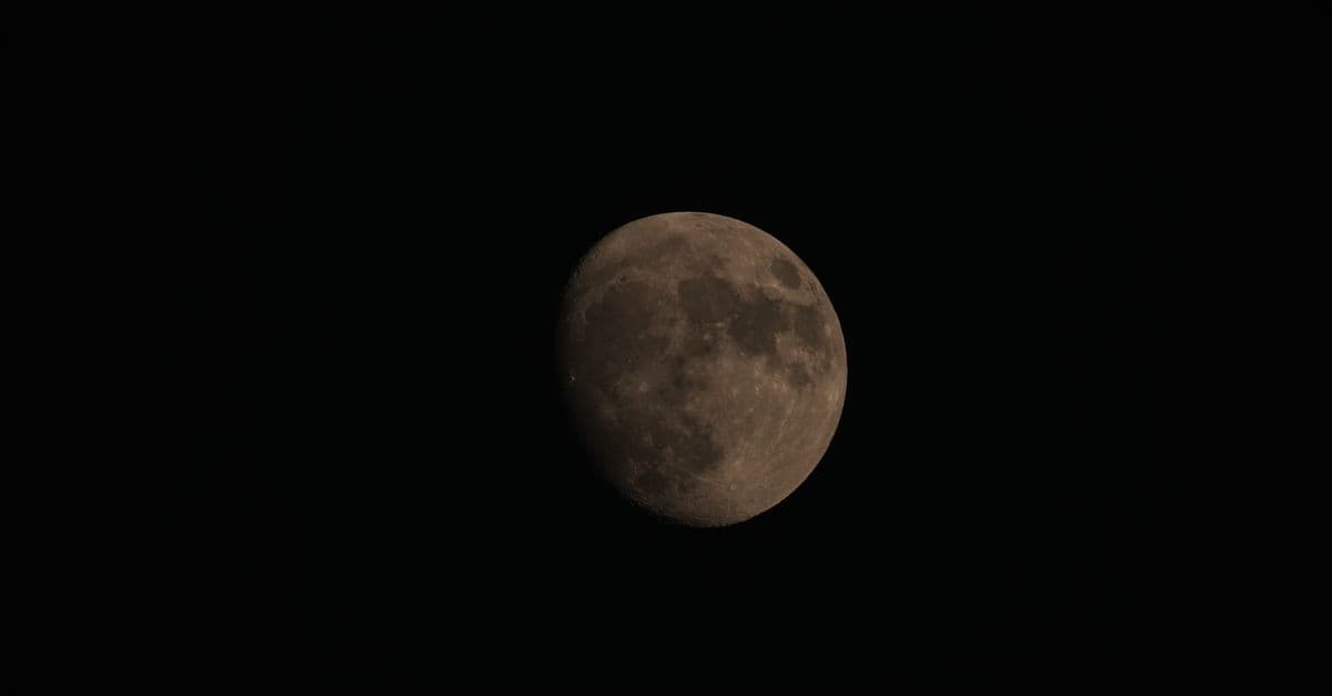 Detailed capture of the moon's surface under dark night sky.