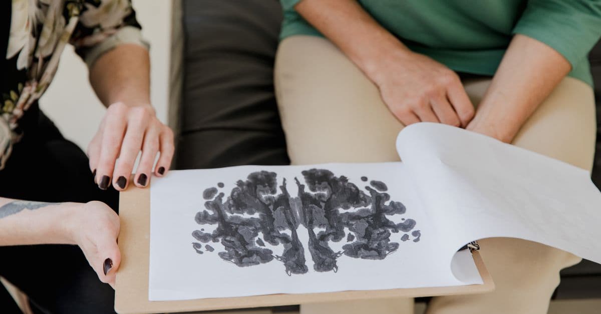 A close-up of a Rorschach inkblot test during a psychotherapy session, highlighting mental health care.