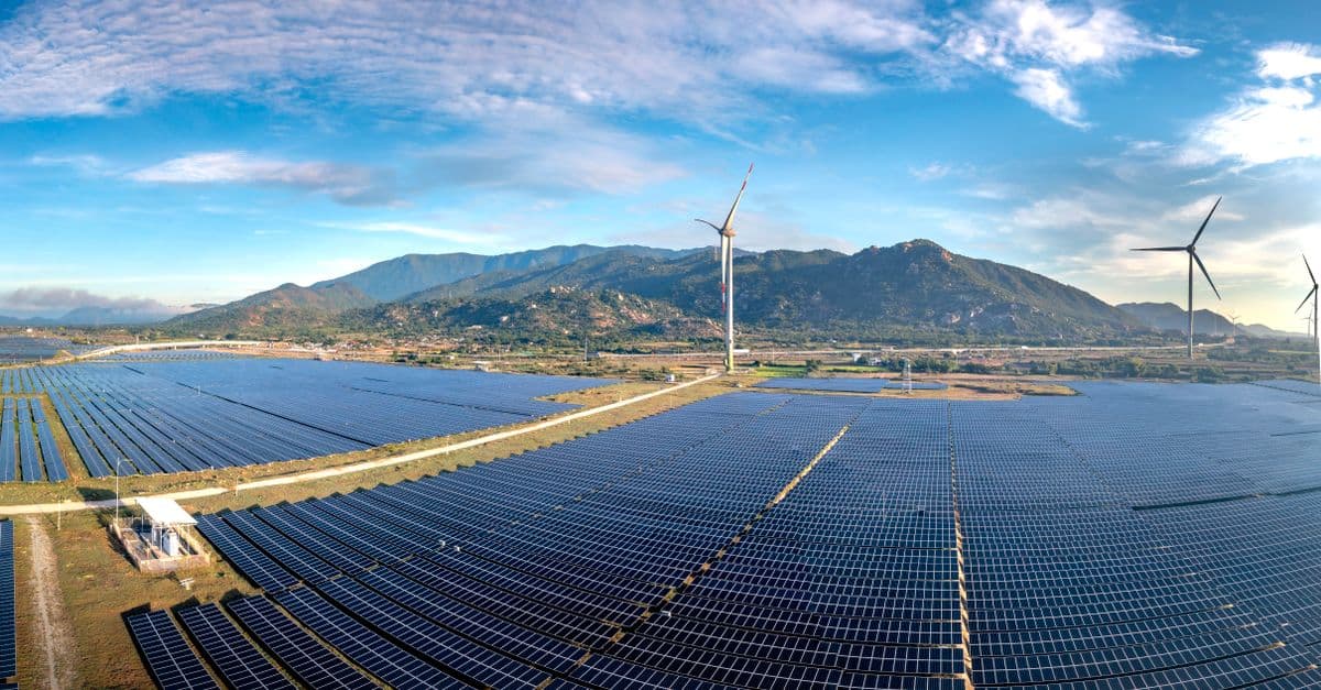 Aerial view of solar panels and wind turbines in Ninh Thuan, Vietnam, showcasing sustainable energy solutions.