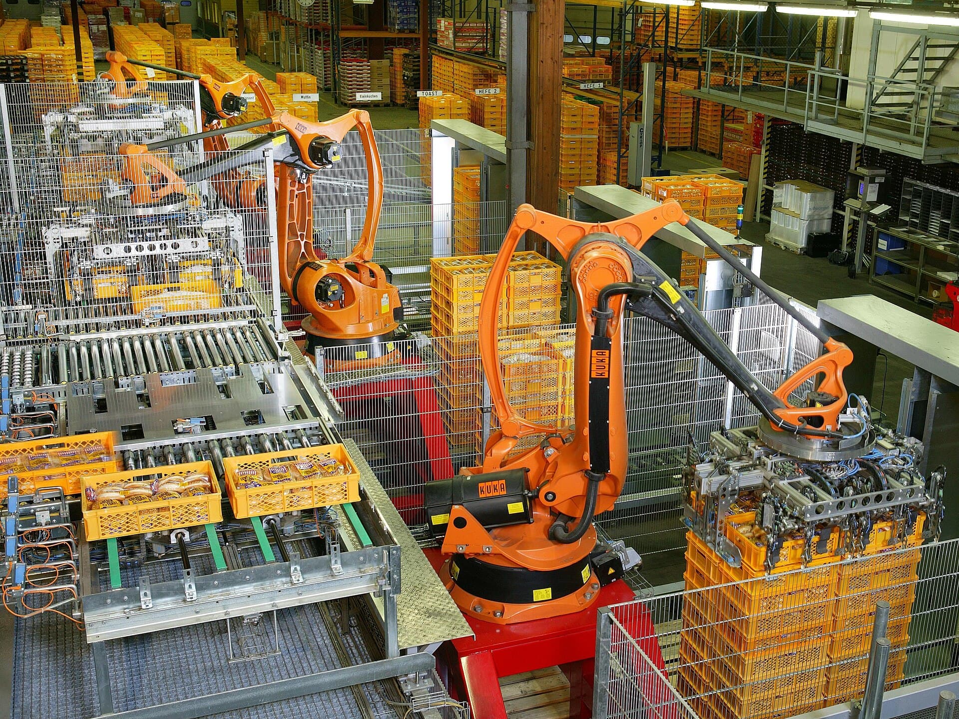 Industrial robots palletizing bread in a factory-automation line.