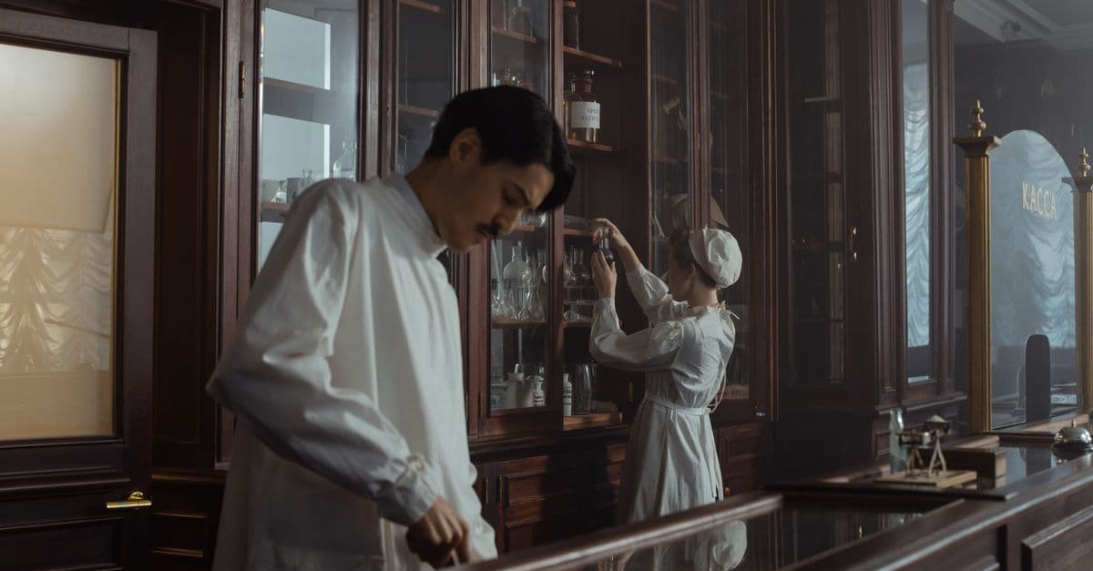 Historical science laboratory scene with researchers in vintage attire exploring shelves filled with glassware.