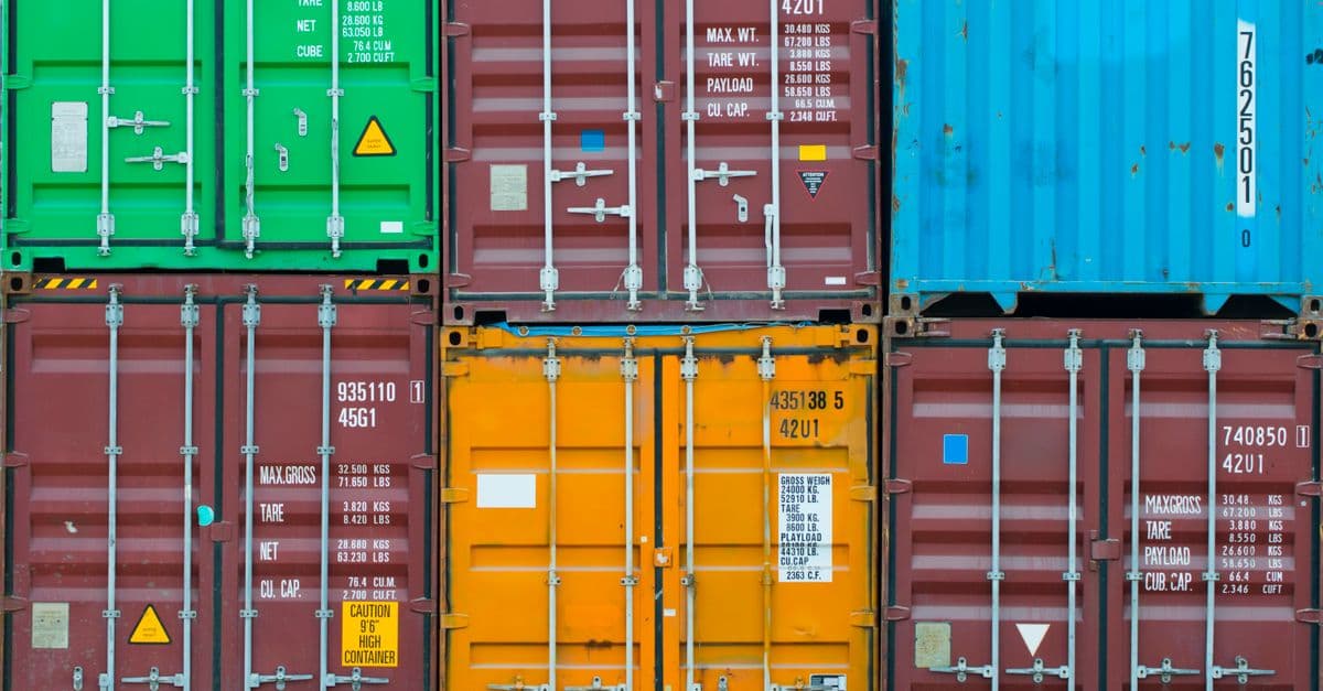 Vividly colored shipping containers stacked together, showcasing global trade and logistics.