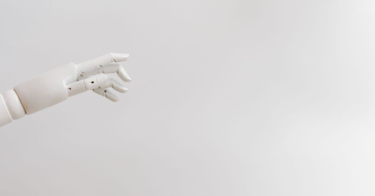 Minimalist image of a robotic hand reaching out on a white background.