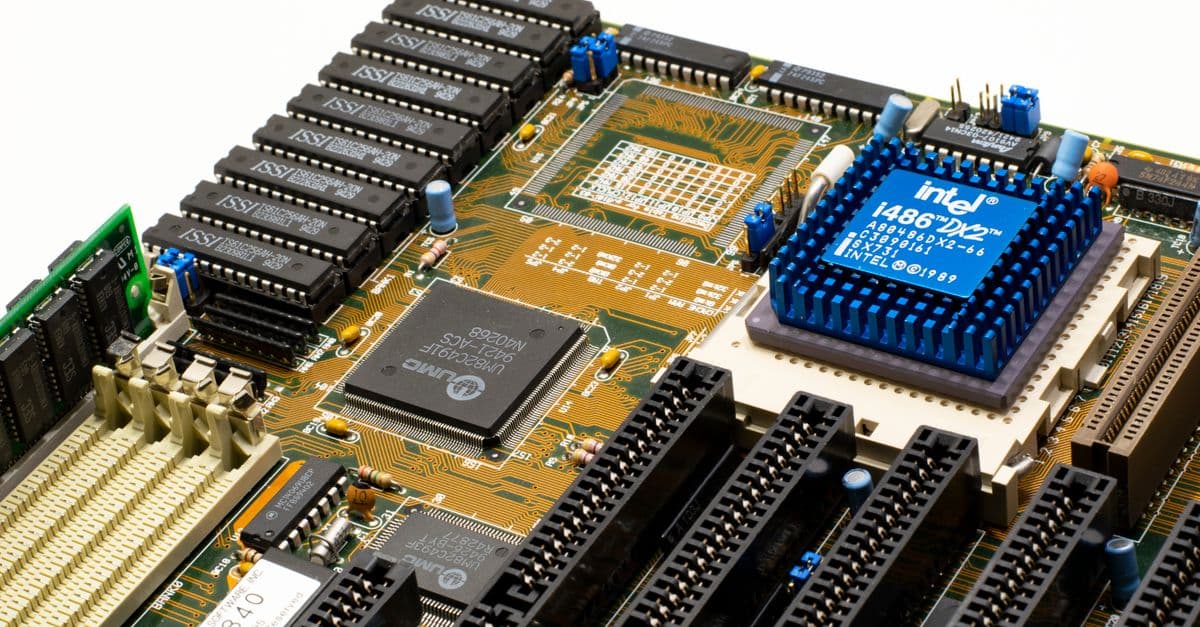 Close-up of vintage Intel 486DX2 CPU on a classic motherboard with electronic components.
